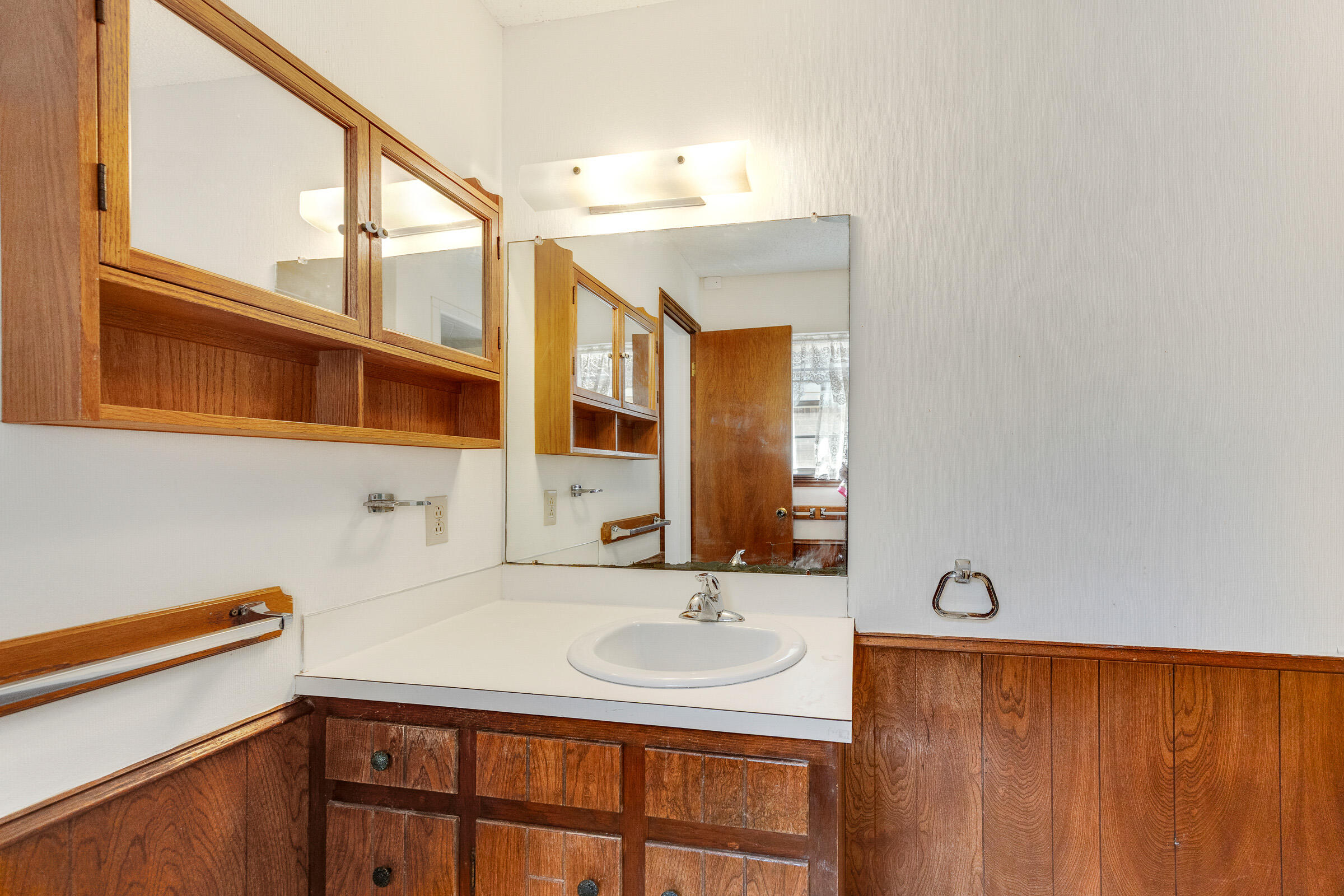 4416 62nd Street Lubbock, TX 79414 - Photo 43 of 70 a bathroom with a sink and a mirror
