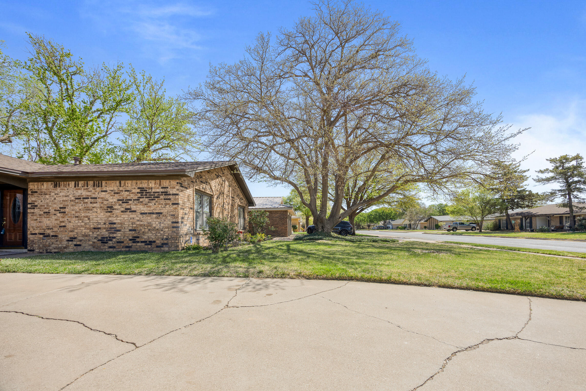 4416 62nd Street Lubbock, TX 79414 - Photo 5 of 70 a front view of a house with a yard and garage