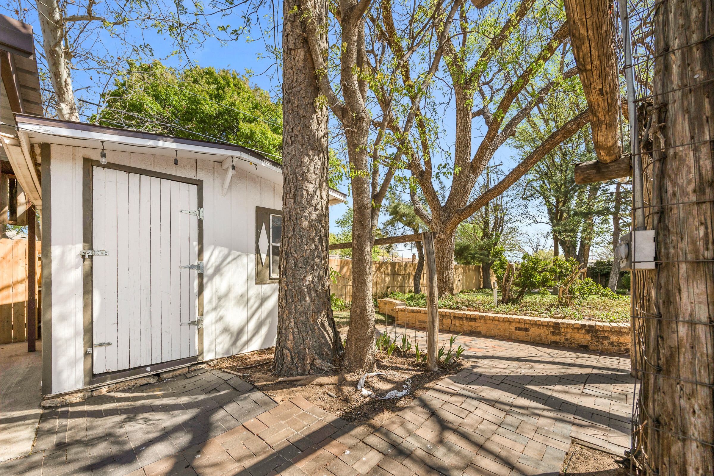 4416 62nd Street Lubbock, TX 79414 - Photo 53 of 70 a view of backyard with large trees and wooden fence