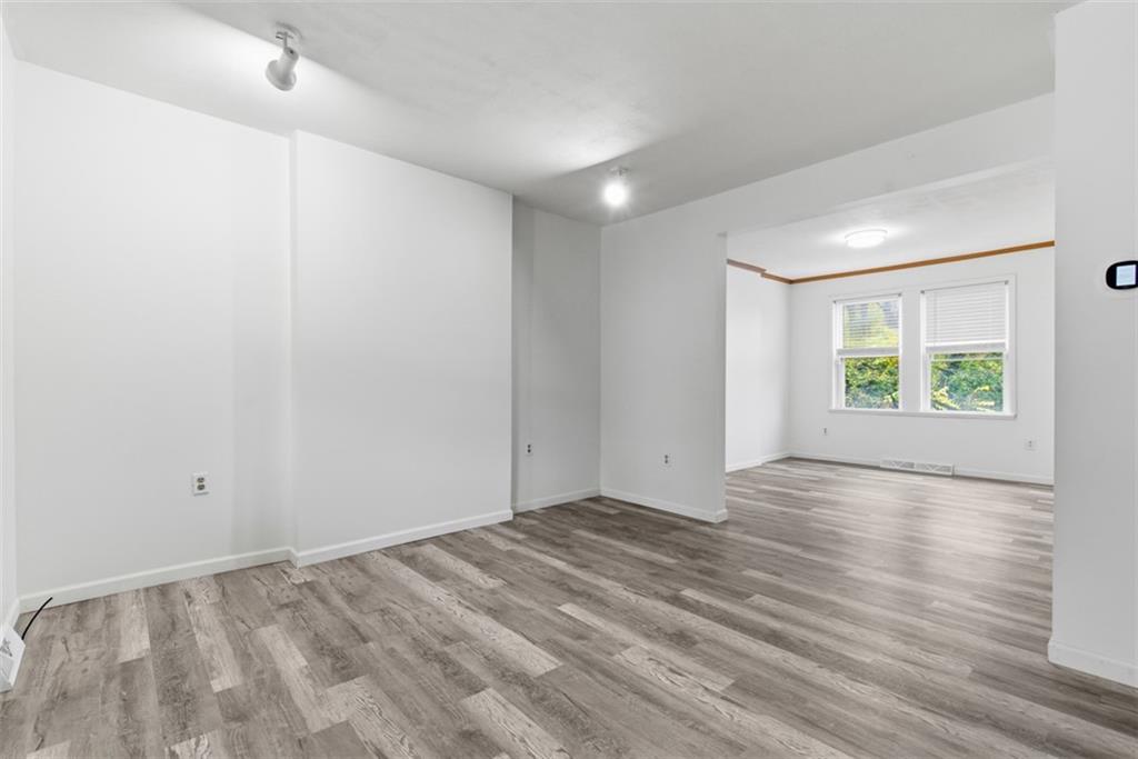 790 Highland Avenue Carnegie, PA 15106 - Photo 4 of 43 a view of an empty room with a window and wooden floor