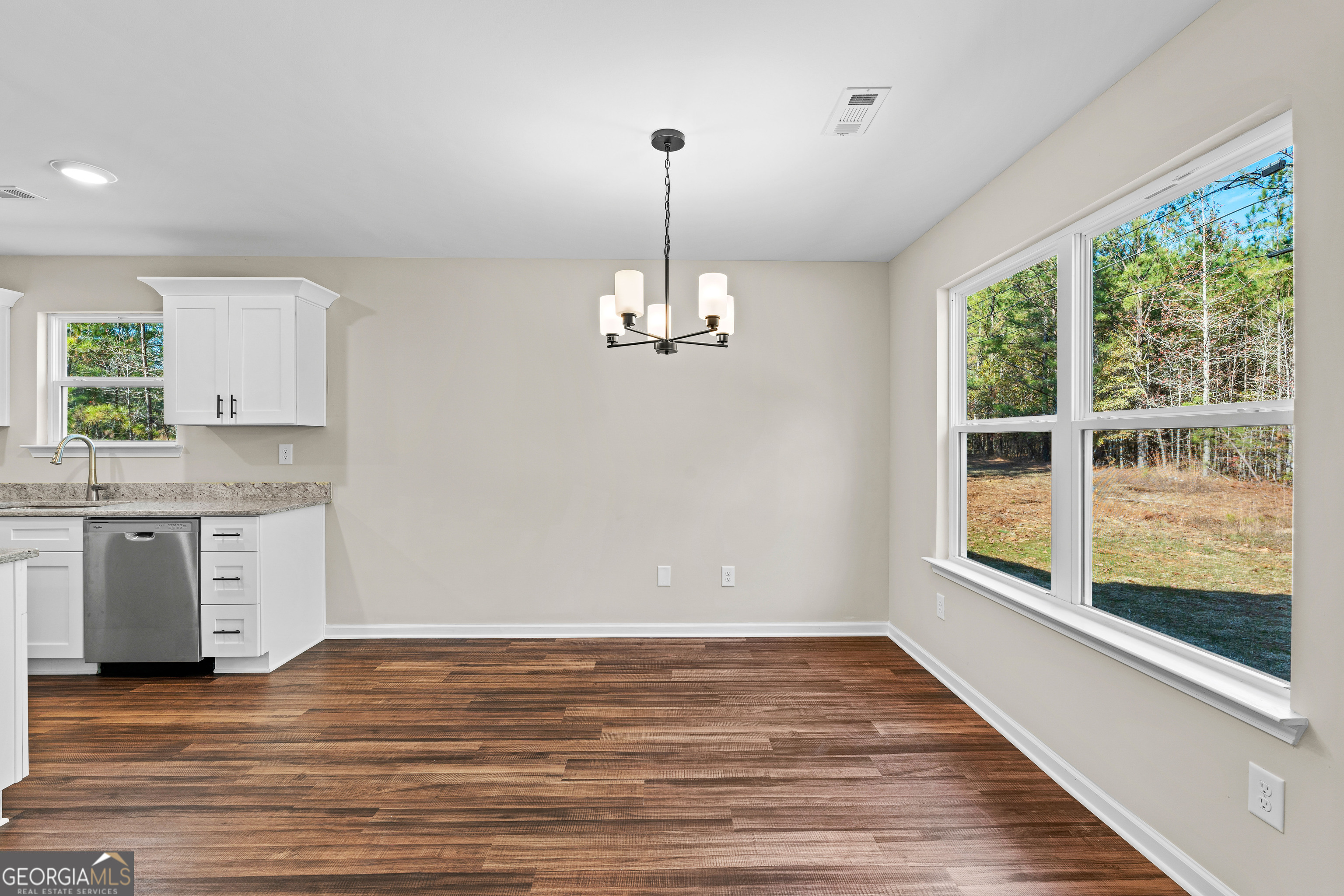500 Todd Road Greenville, GA 30222 - Photo 11 of 47 a view of a kitchen with a stove wooden cabinets and a large window