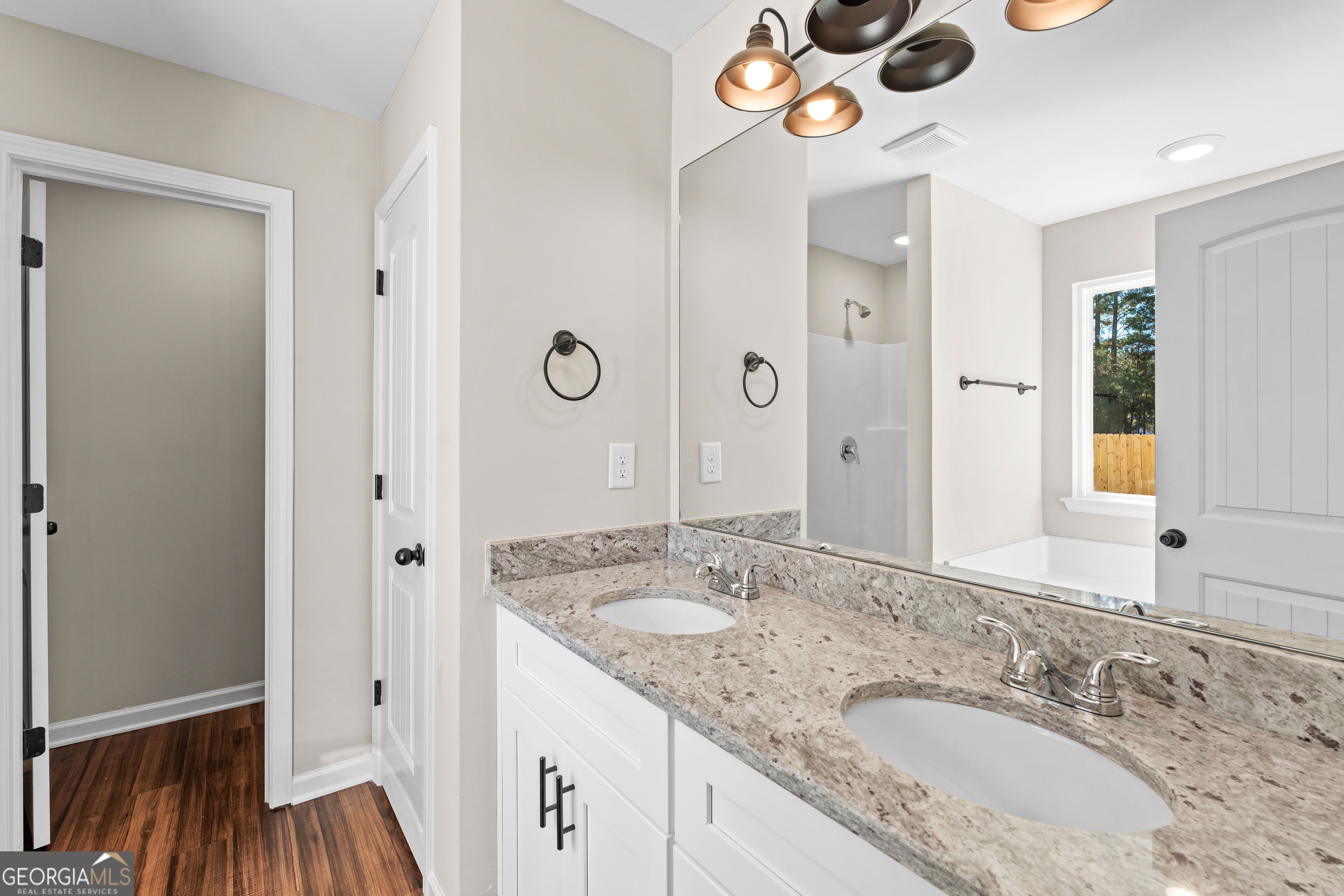 500 Todd Road Greenville, GA 30222 - Photo 33 of 47 a bathroom with a granite countertop sink and a mirror