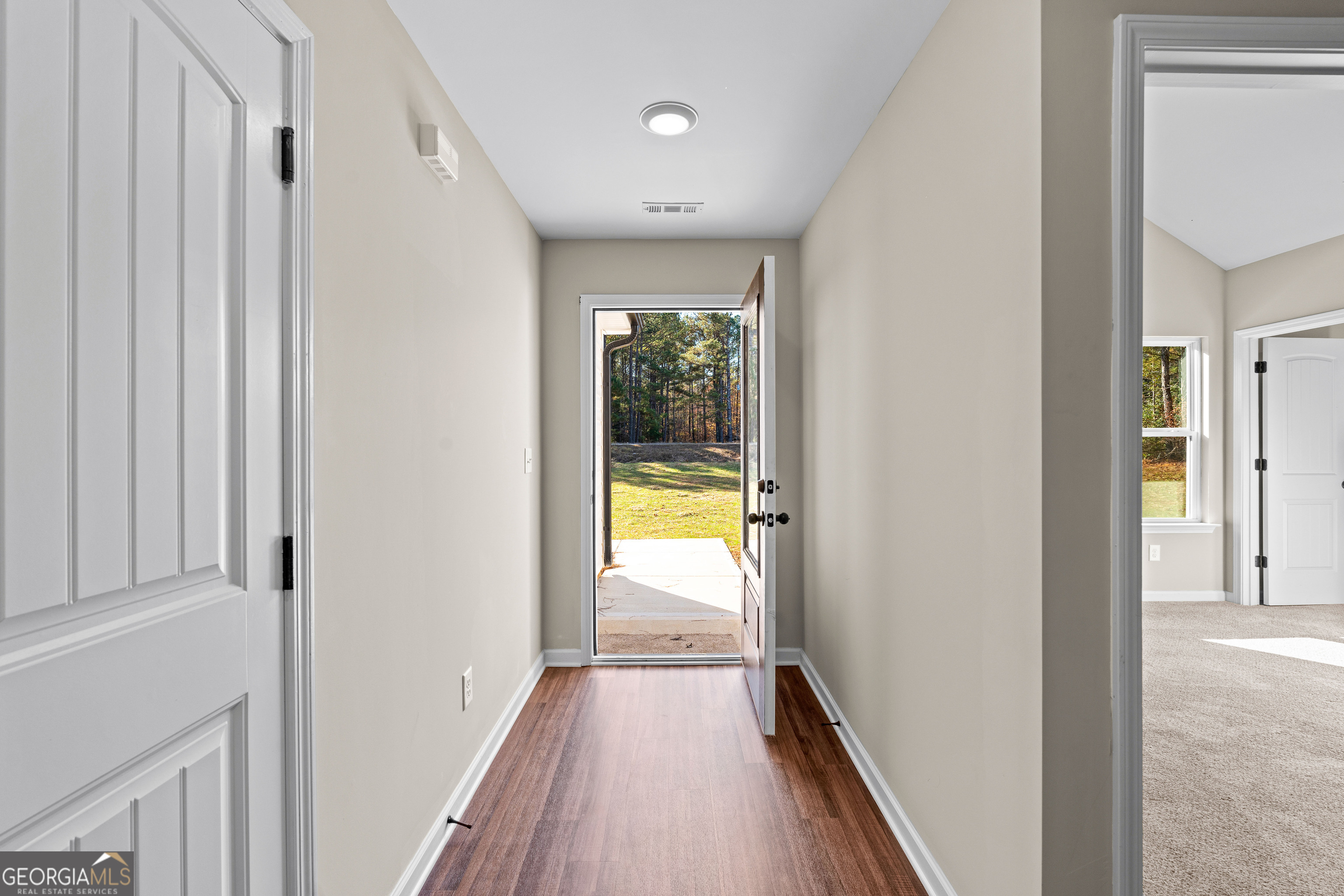 500 Todd Road Greenville, GA 30222 - Photo 5 of 47 a view of a hallway with wooden floor and a bathroom