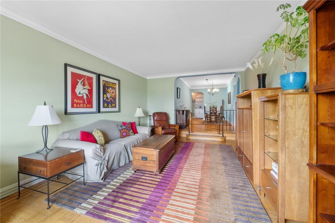 4445 Post Road, Unit 7D Bronx, NY 10471 - Photo 3 of 13 Living room featuring ornamental molding, an inviting chandelier, and parquet floors
