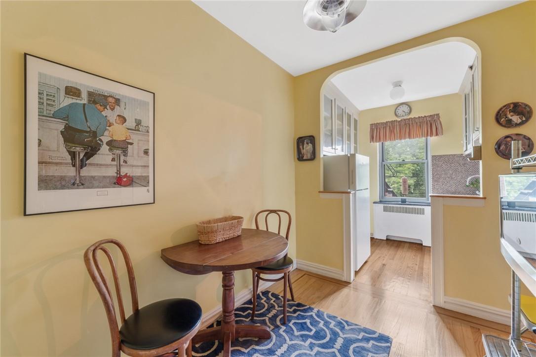 4445 Post Road, Unit 7D Bronx, NY 10471 - Photo 6 of 13 Dining area with radiator and light wood-type flooring