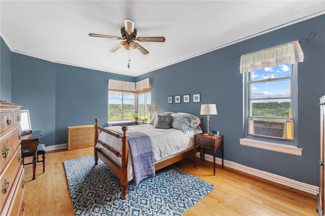 4445 Post Road, Unit 7D Bronx, NY 10471 - Photo 10 of 13 Bedroom featuring cooling unit, crown molding, light wood-type flooring, and ceiling fan