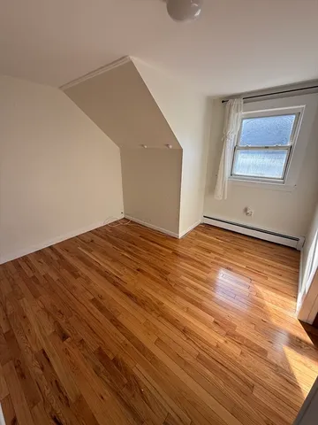 a view of an empty room and wooden floor