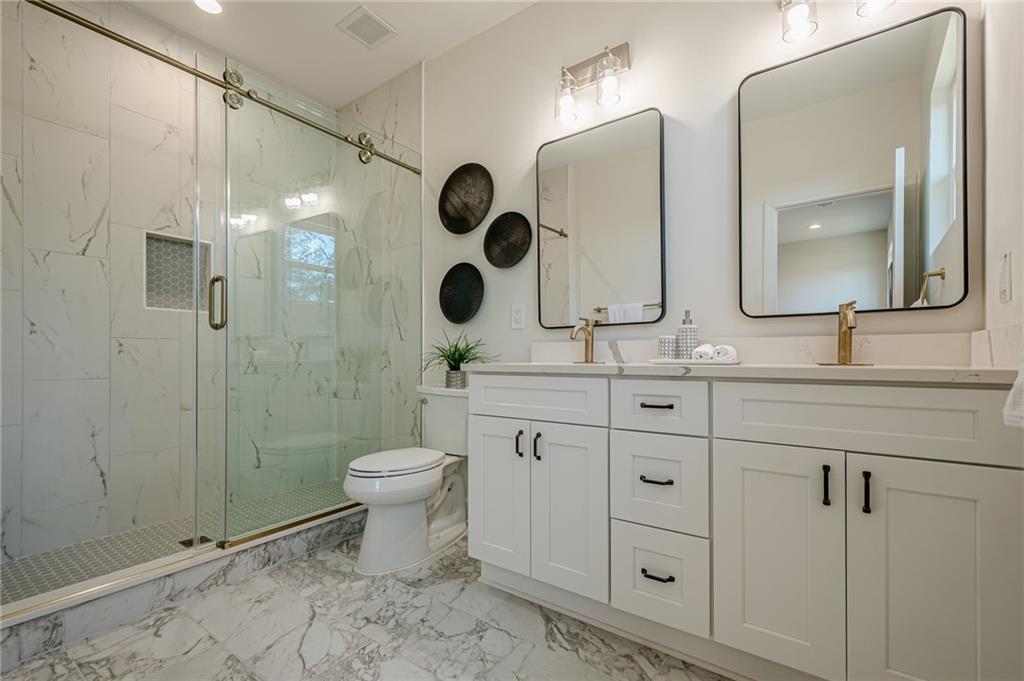 5249 Moon Road Powder Springs, GA 30127 - Photo 11 of 43 a bathroom with 2 sink toilet and shower