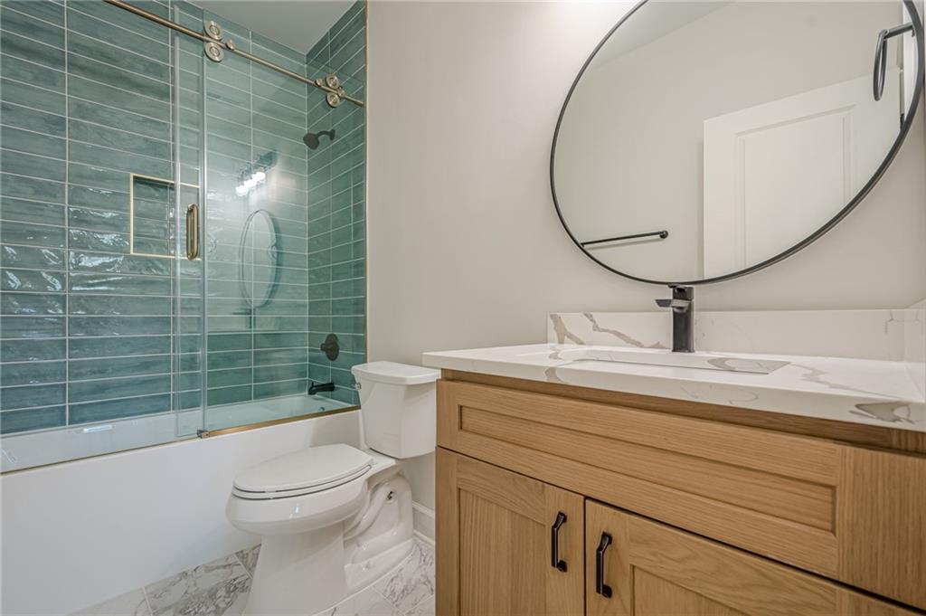 5249 Moon Road Powder Springs, GA 30127 - Photo 13 of 43 a bathroom with a sink a toilet and shower