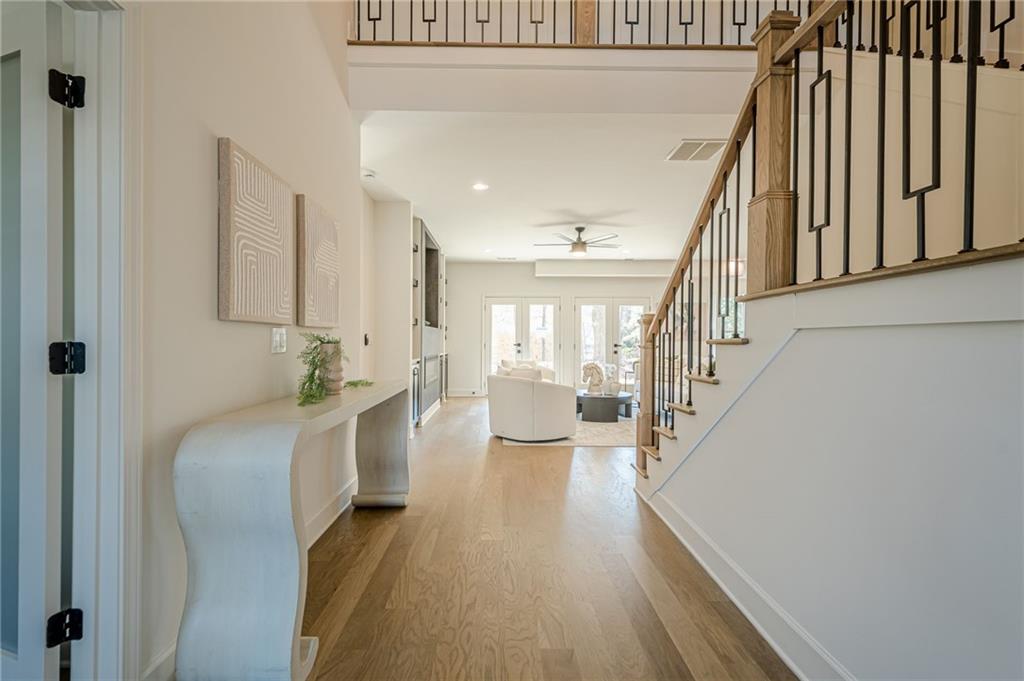5249 Moon Road Powder Springs, GA 30127 - Photo 20 of 43 a hallway with white cabinets and wooden floor
