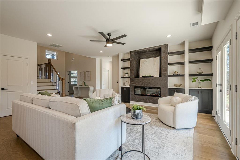 5249 Moon Road Powder Springs, GA 30127 - Photo 23 of 43 a living room with fireplace furniture and a wooden floor