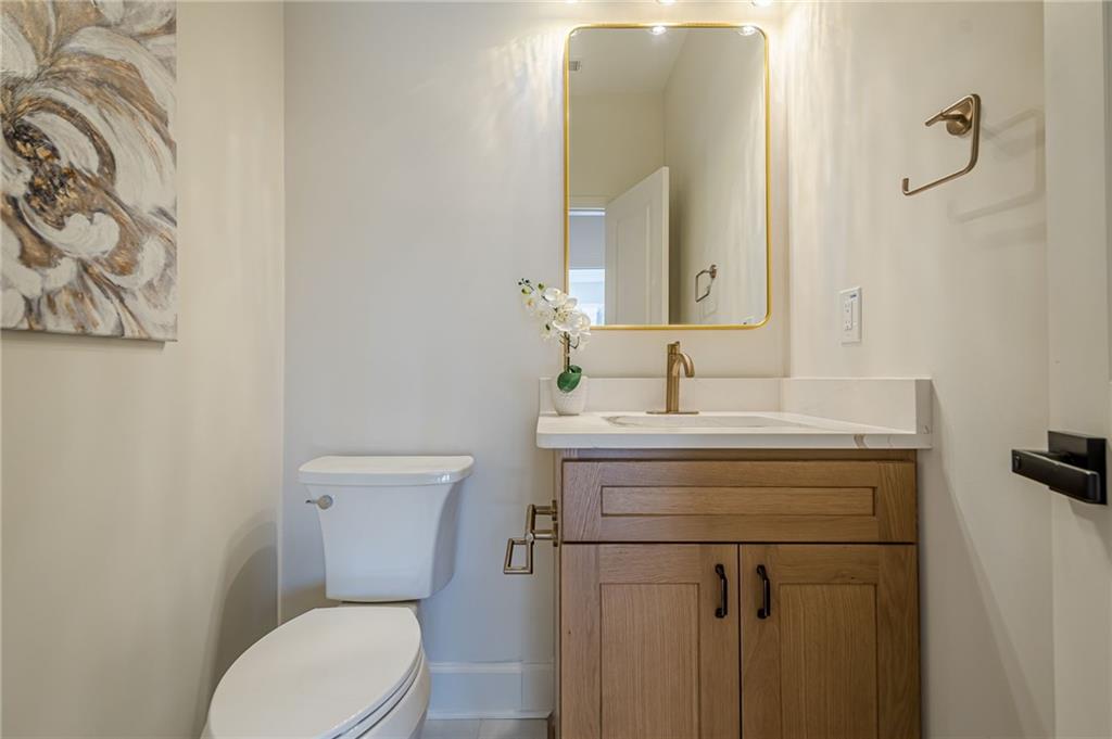 5249 Moon Road Powder Springs, GA 30127 - Photo 25 of 43 a bathroom with a toilet sink and mirror