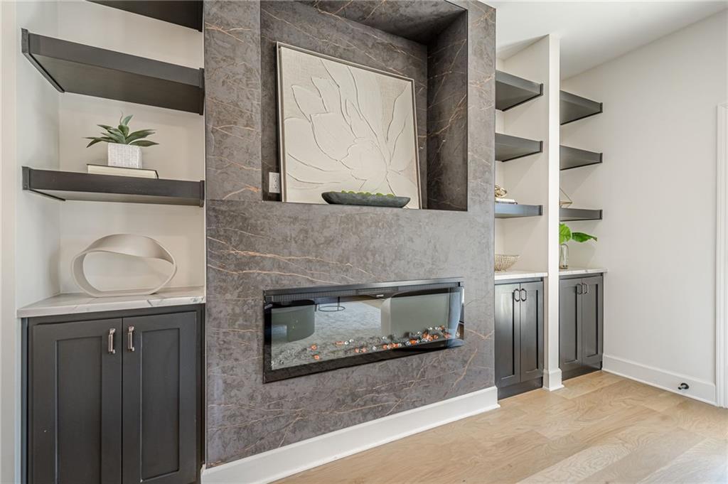 5249 Moon Road Powder Springs, GA 30127 - Photo 3 of 43 a living room with a fireplace and a wooden floor