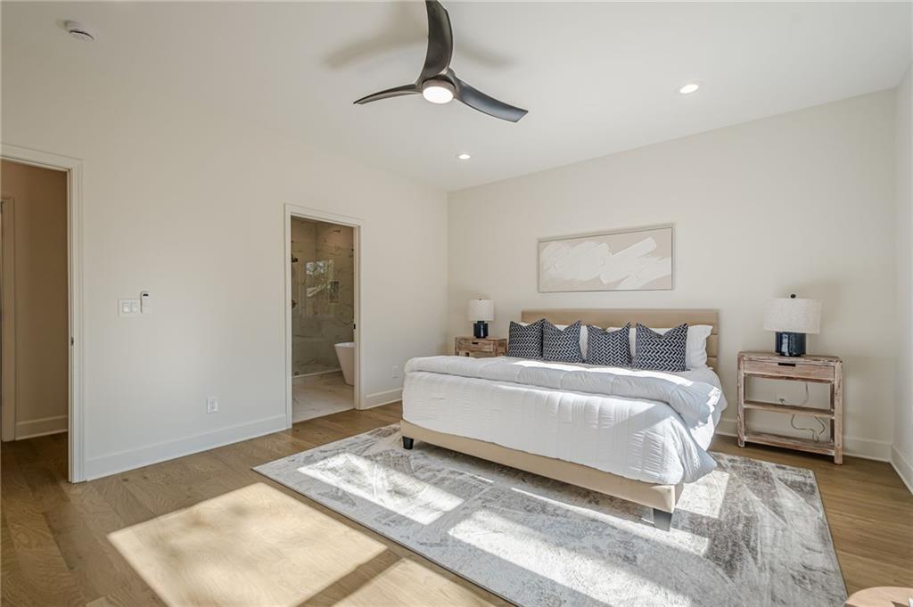 5249 Moon Road Powder Springs, GA 30127 - Photo 31 of 43 a spacious bedroom with a bed and a couch