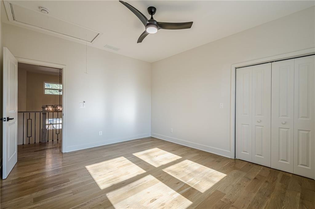 5249 Moon Road Powder Springs, GA 30127 - Photo 37 of 43 an empty room with wooden floor cabinet and windows