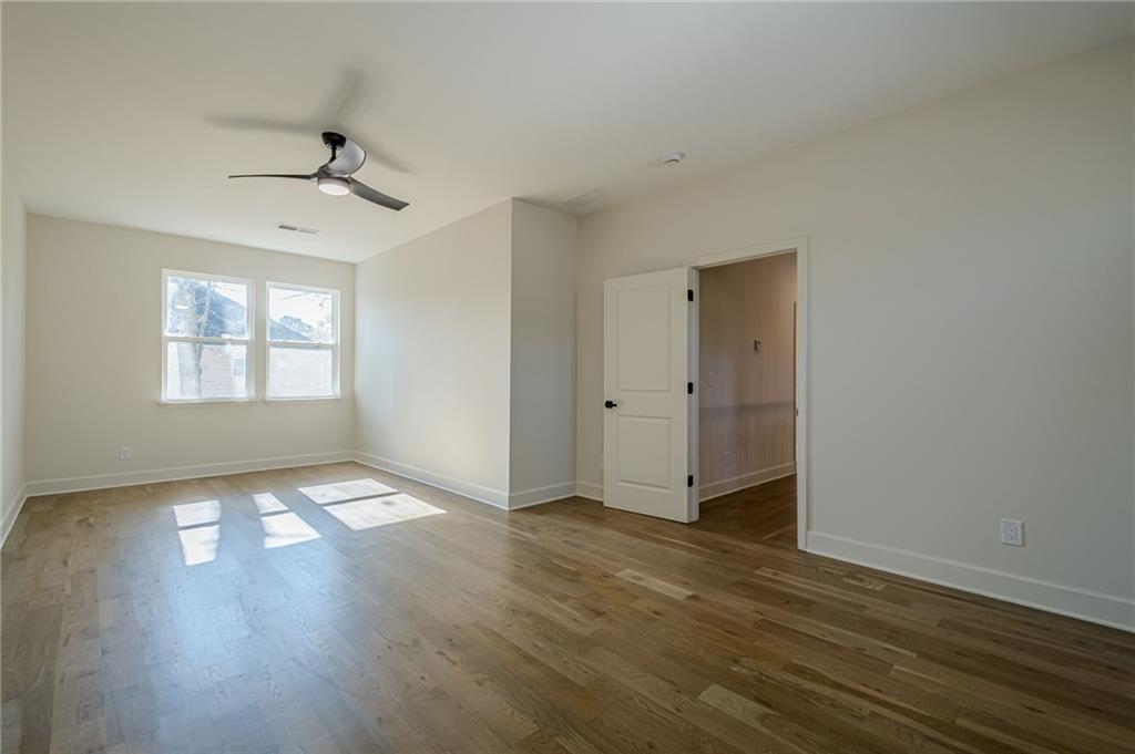 5249 Moon Road Powder Springs, GA 30127 - Photo 39 of 43 a view of an empty room with wooden floor and a window