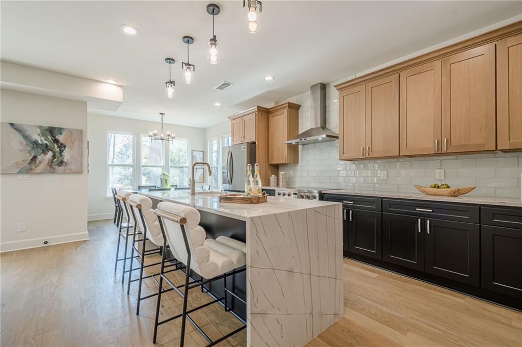 5249 Moon Road Powder Springs, GA 30127 - Photo 4 of 43 a kitchen with a dining table chairs and white cabinets