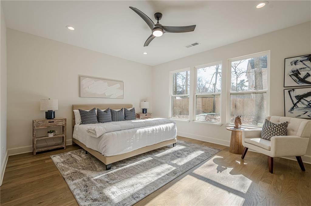5249 Moon Road Powder Springs, GA 30127 - Photo 5 of 43 a spacious bedroom with a bed a couch and a window
