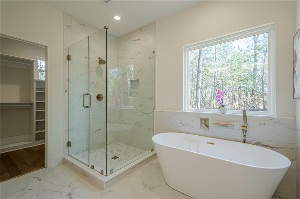 5249 Moon Road Powder Springs, GA 30127 - Photo 6 of 43 a white bath tub sitting next to a shower