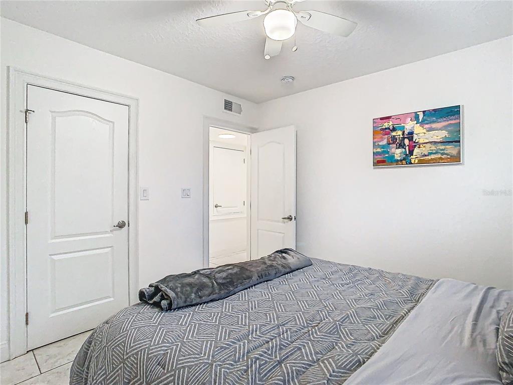 3025 Long Street Orlando, FL 32805 - Photo 16 of 24 a bedroom with a bed and a painting on the wall