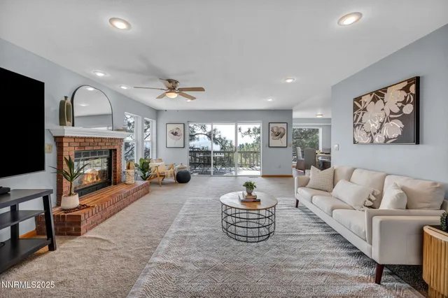 a living room with furniture a fireplace and a flat screen tv