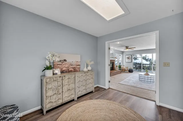a living room with furniture a fireplace and a large window with garden view