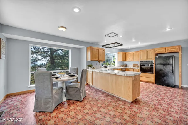 a living room with furniture a flat screen tv and a table