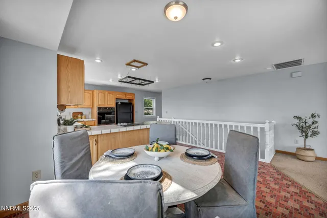 a kitchen with kitchen island granite countertop a sink and a counter top space