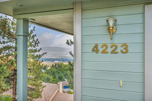 a front view of house along with deck and utility room