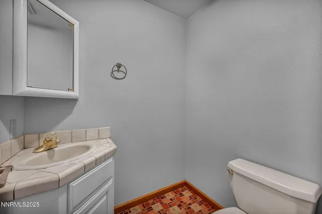 a bathroom with a sink double vanity granite tub and shower