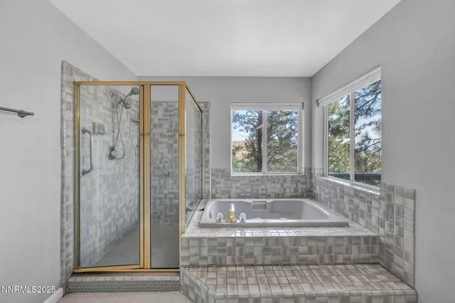 a bathroom with a tub a shower and sink