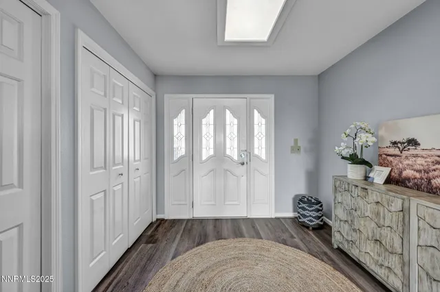 a living room with hard wood floor and a ceiling fan