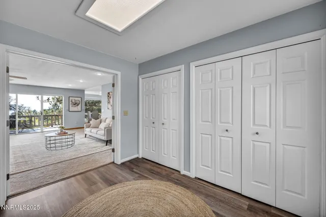 a living room with furniture a flat screen tv and a large window