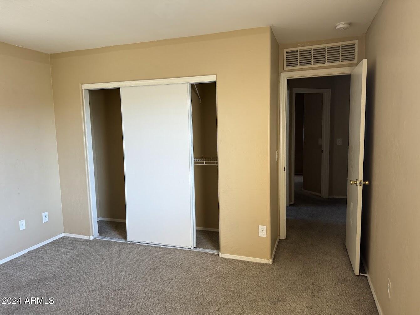 5322 Odeum Lane Phoenix, AZ 85043 - Photo 12 of 19 a view of an empty room with closet and wooden floor