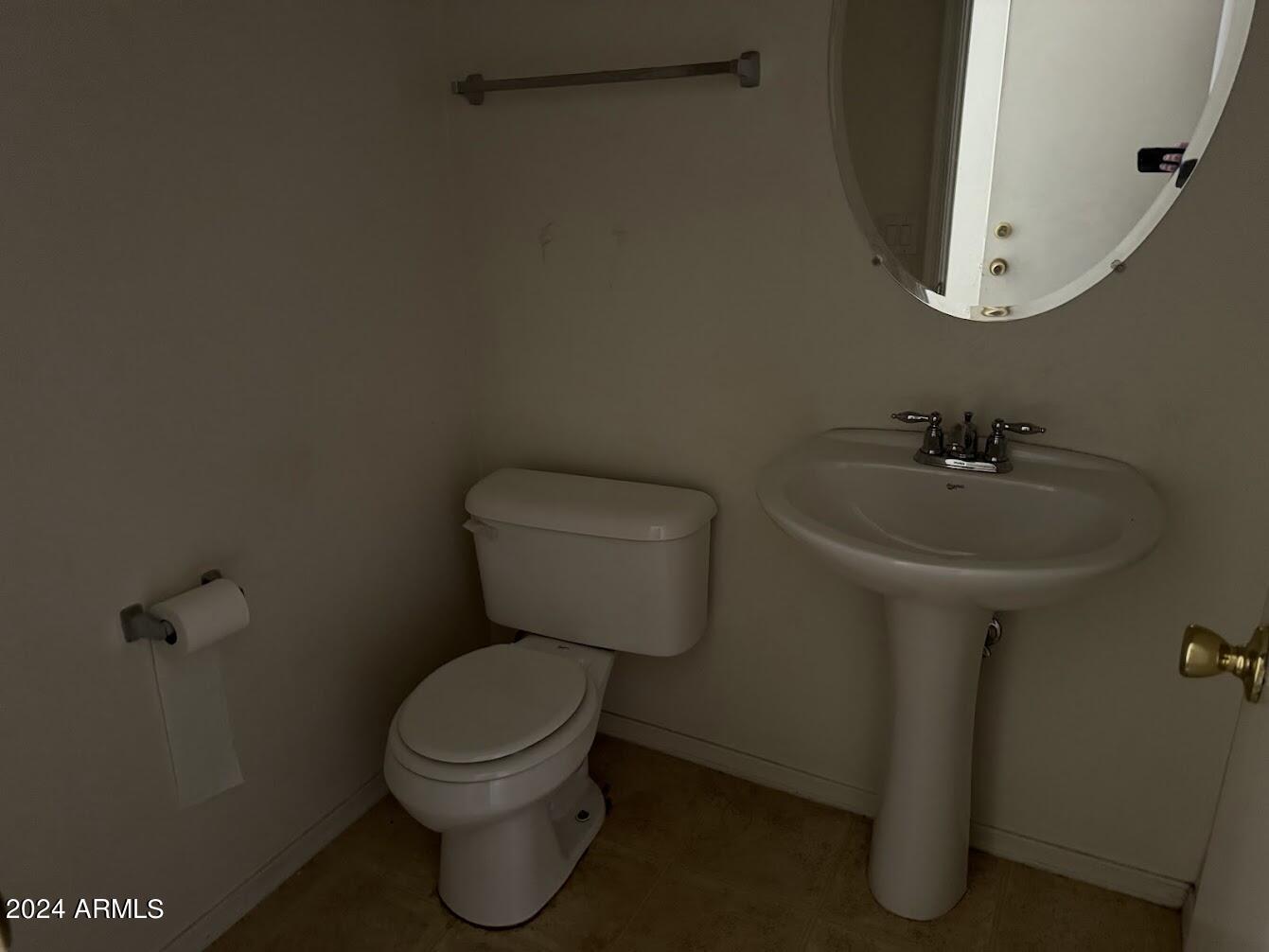 5322 Odeum Lane Phoenix, AZ 85043 - Photo 16 of 19 a bathroom with a toilet sink and mirror
