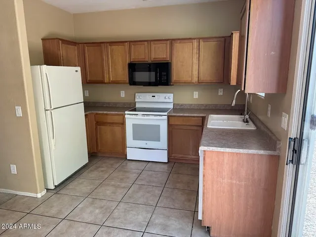 a kitchen with a refrigerator sink and microwave