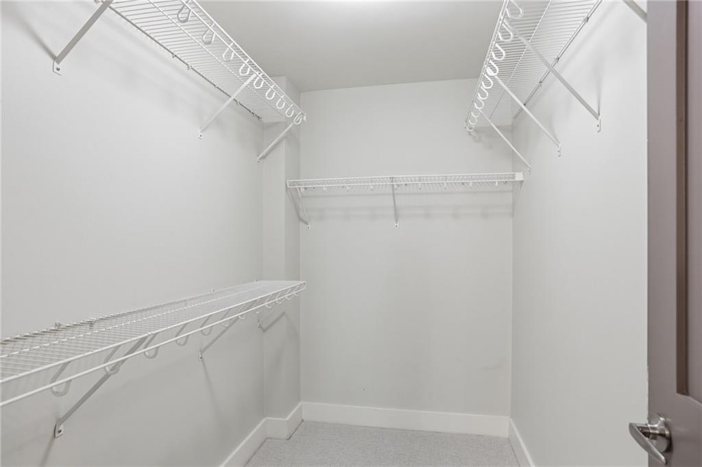 1100 Howell Mill Road Northwest, Unit 608 Atlanta, GA 30318 - Photo 20 of 37 a view of walk in closet with empty racks