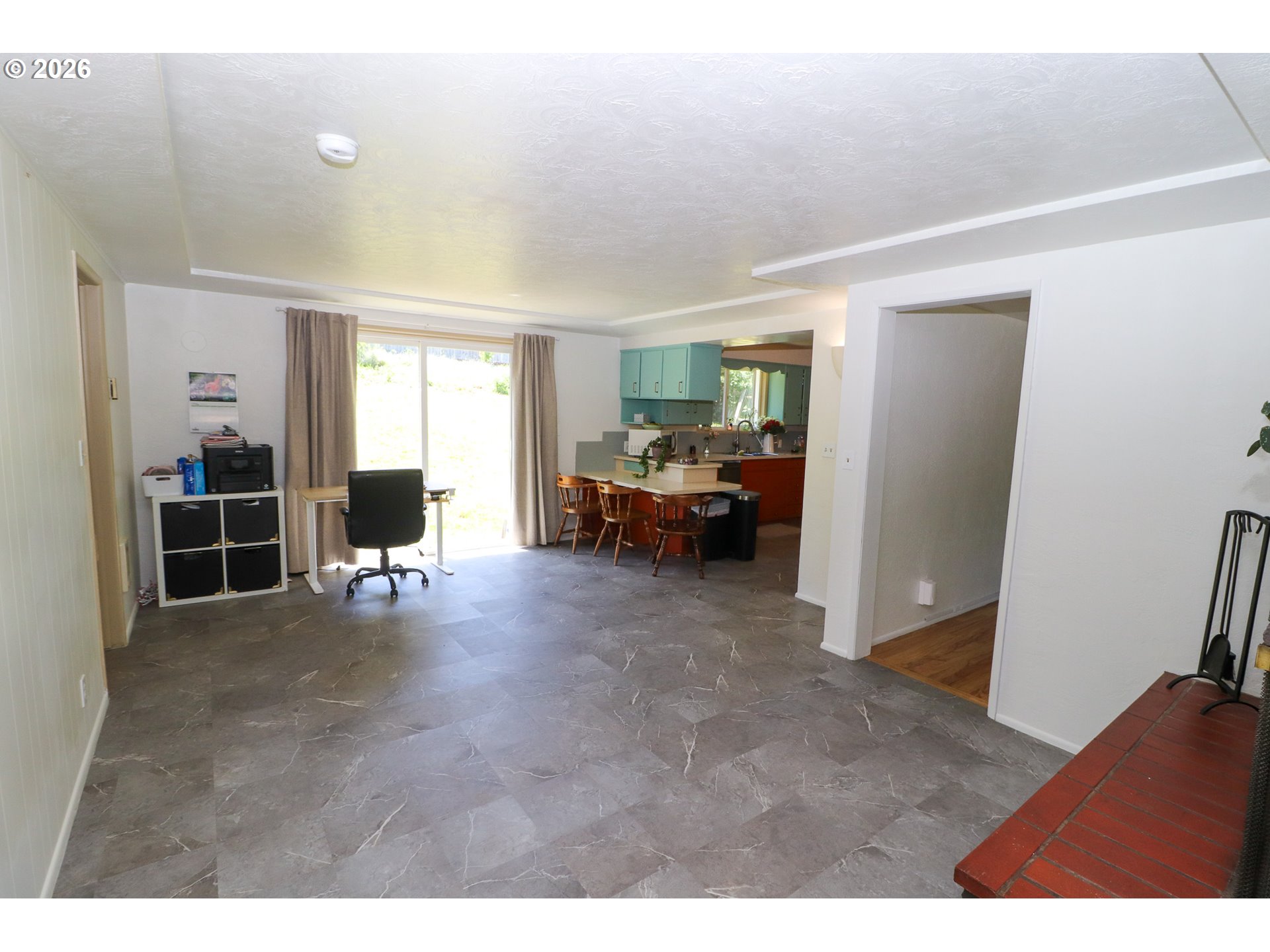 7077 Main Street Springfield, OR 97478 - Photo 12 of 34 a living room with furniture and a refrigerator