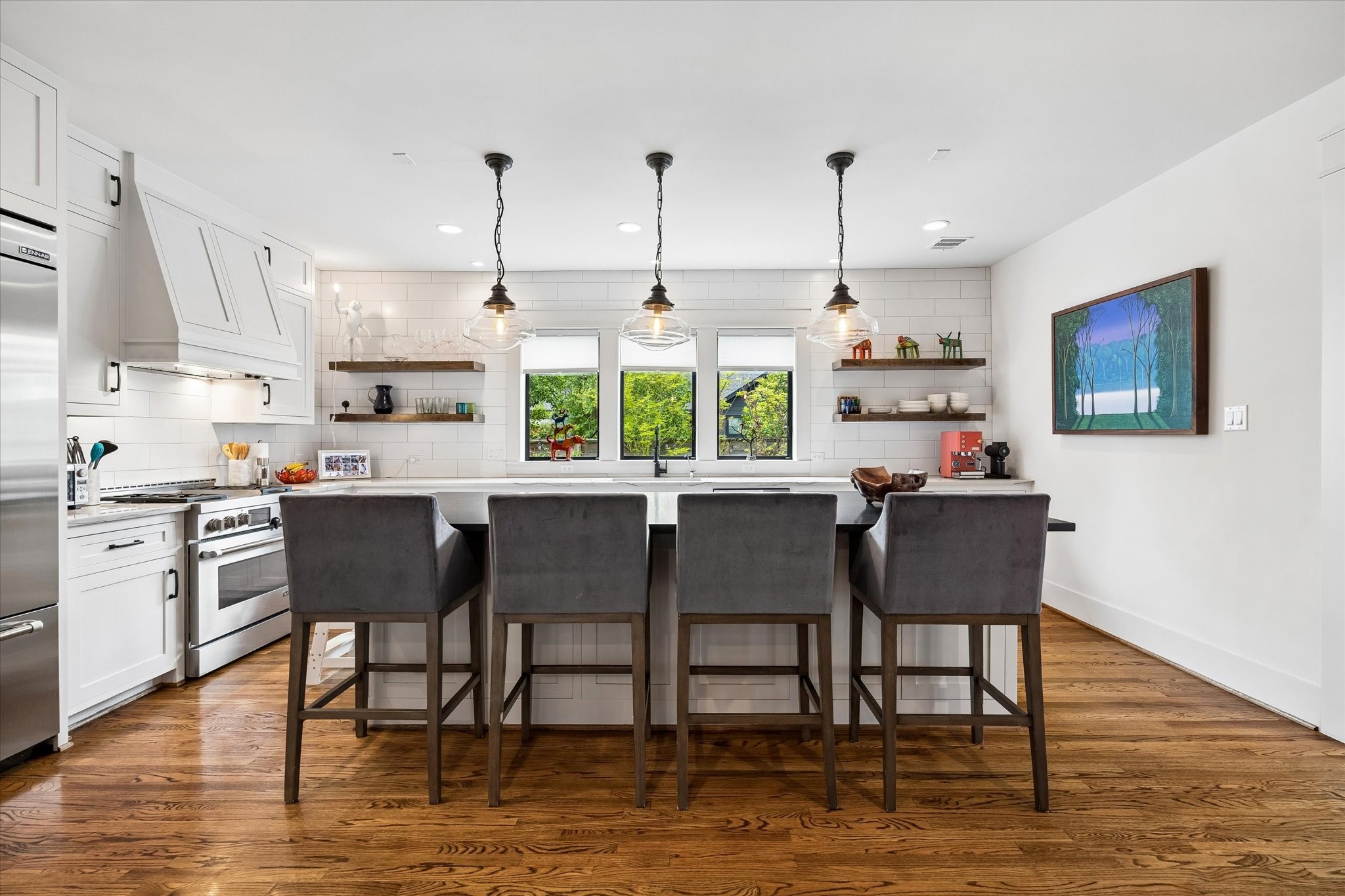 402 East 26th Street Houston, TX 77008 - Photo 13 of 35 a kitchen with stainless steel appliances granite countertop a table chairs and a wooden cabinets