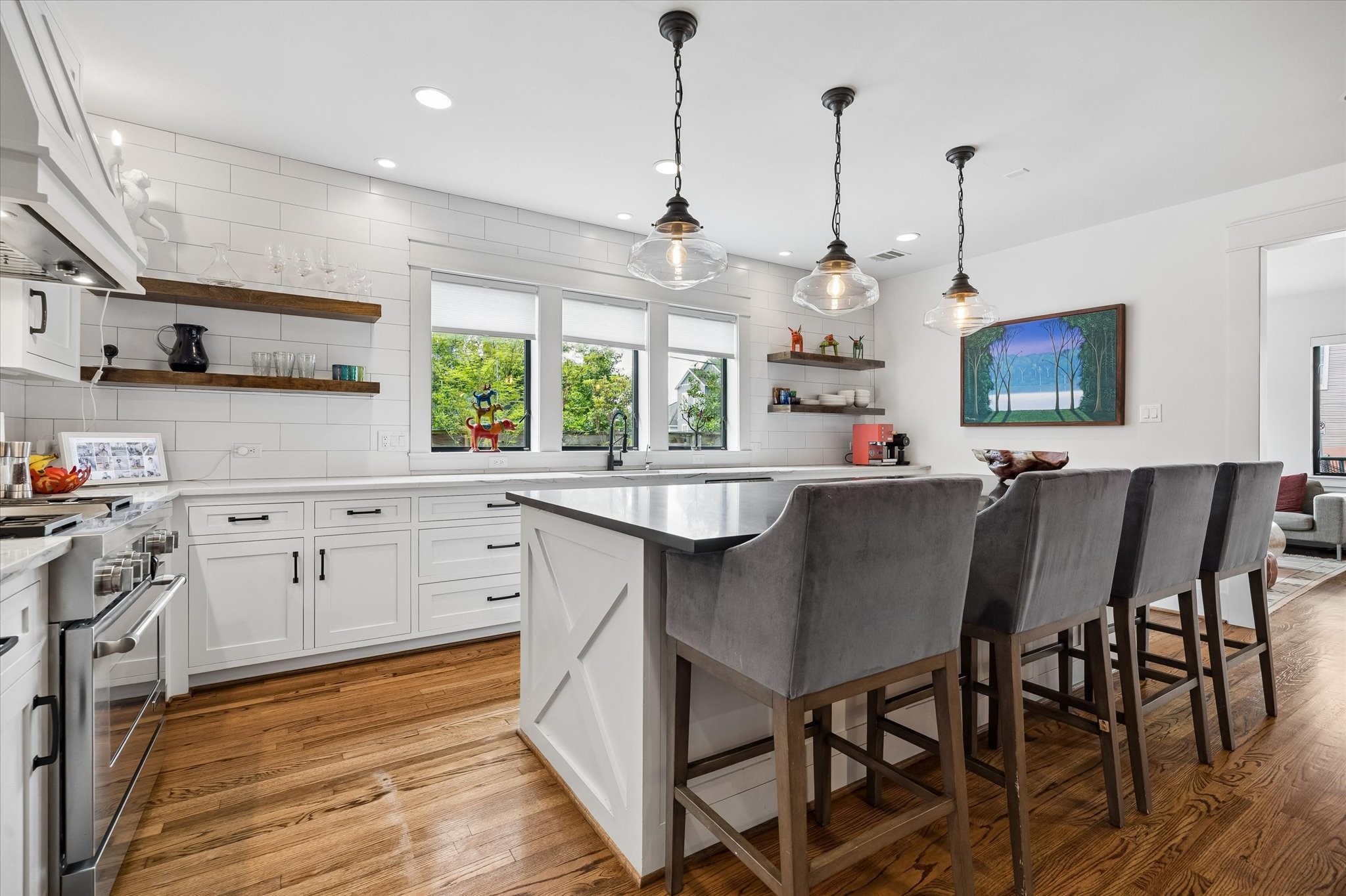 402 East 26th Street Houston, TX 77008 - Photo 14 of 35 a kitchen with stainless steel appliances granite countertop a stove a sink a dining table and chairs with wooden floor