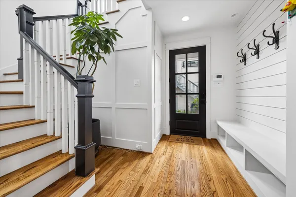 a view of entryway with wooden floor and stairs