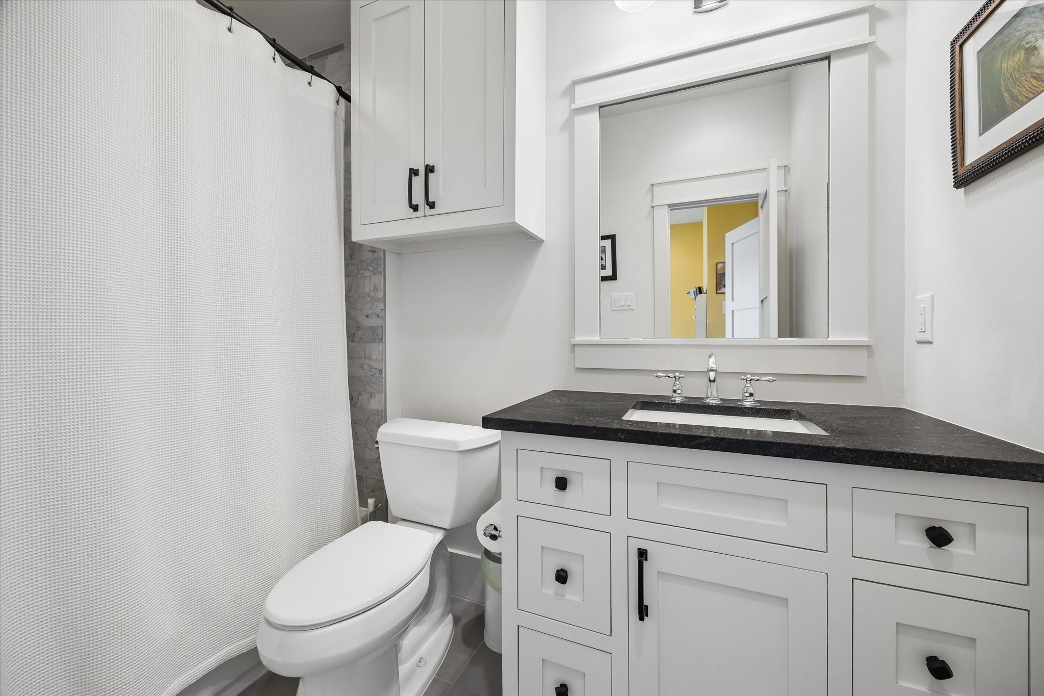 402 East 26th Street Houston, TX 77008 - Photo 23 of 35 a bathroom with a granite countertop toilet sink and mirror