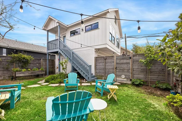 a view of a chair and table in backyard of the house