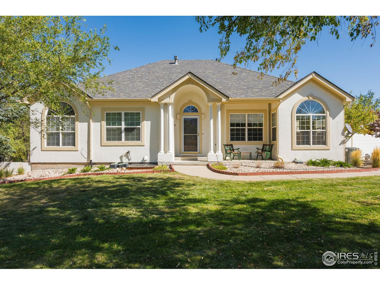 a front view of a house with a garden and porch