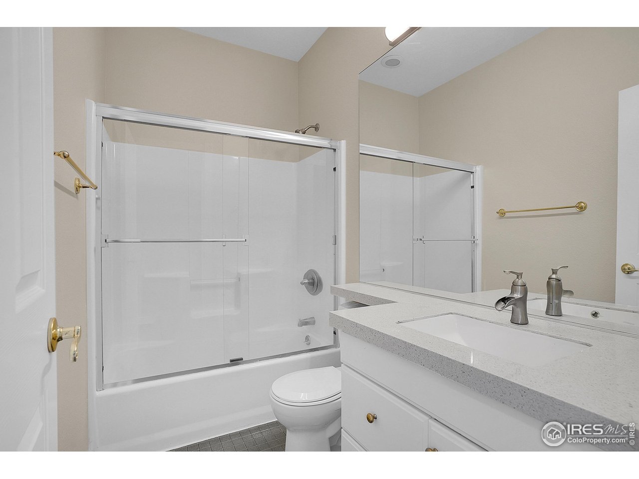 410 High Court Fort Collins, CO 80521 - Photo 18 of 37 a bathroom with a sink a toilet a shower and a mirror