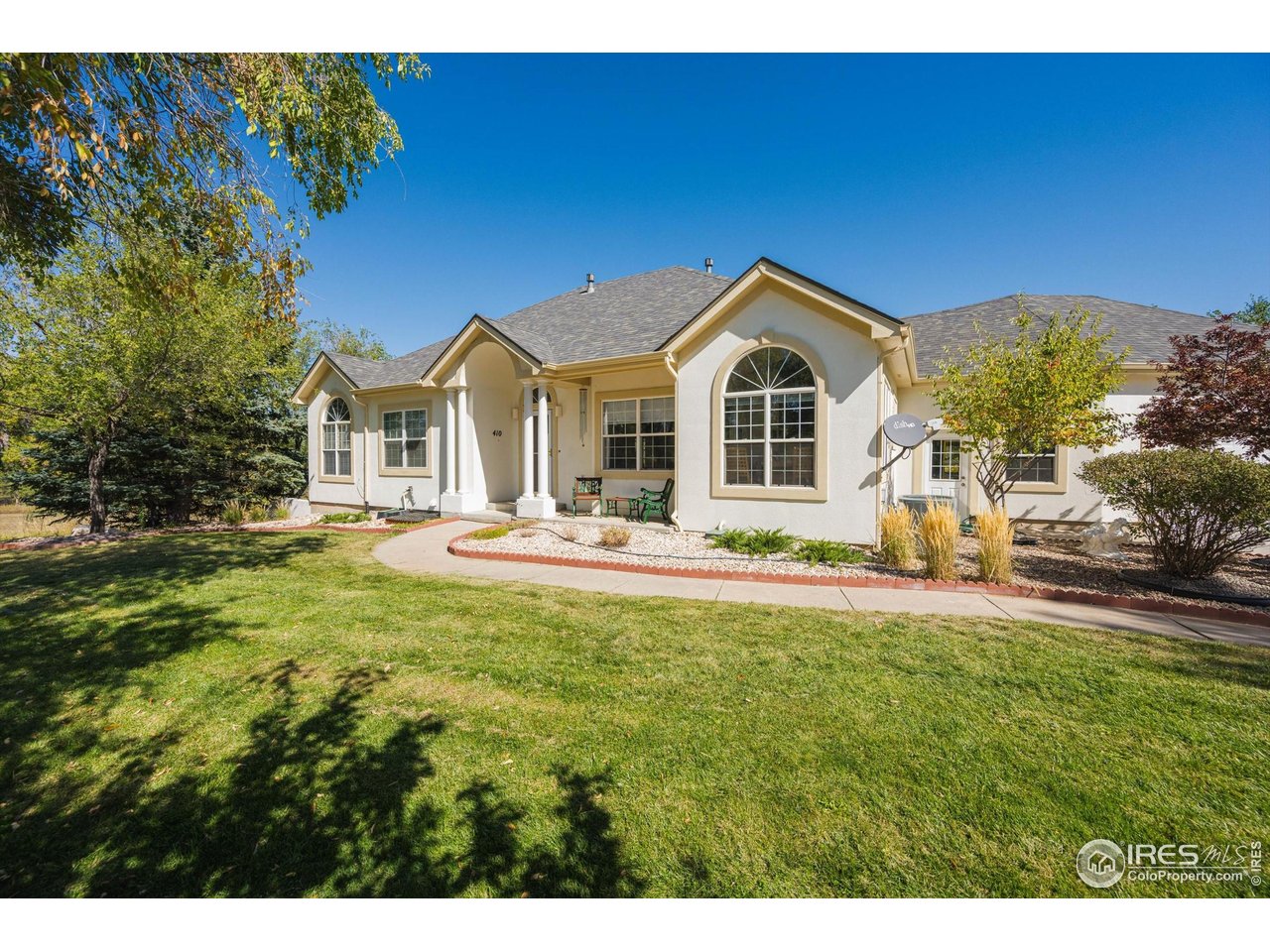 410 High Court Fort Collins, CO 80521 - Photo 2 of 37 a front view of a house with a garden and yard