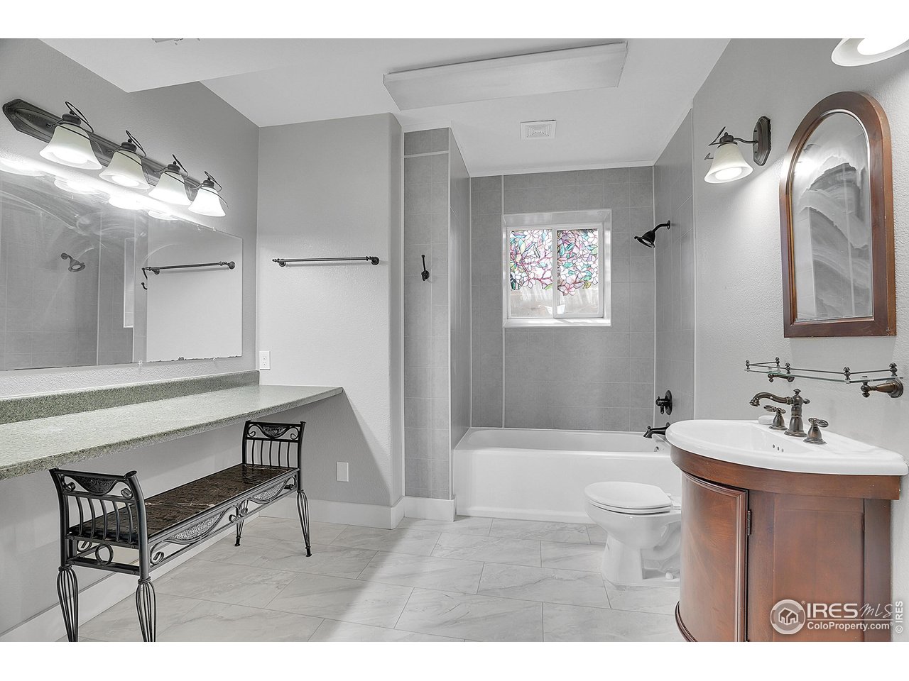 410 High Court Fort Collins, CO 80521 - Photo 22 of 37 a bathroom with a sink a mirror and a bathtub