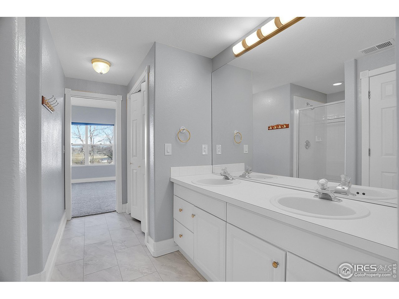 410 High Court Fort Collins, CO 80521 - Photo 24 of 37 a bathroom with a sink double vanity and a mirror