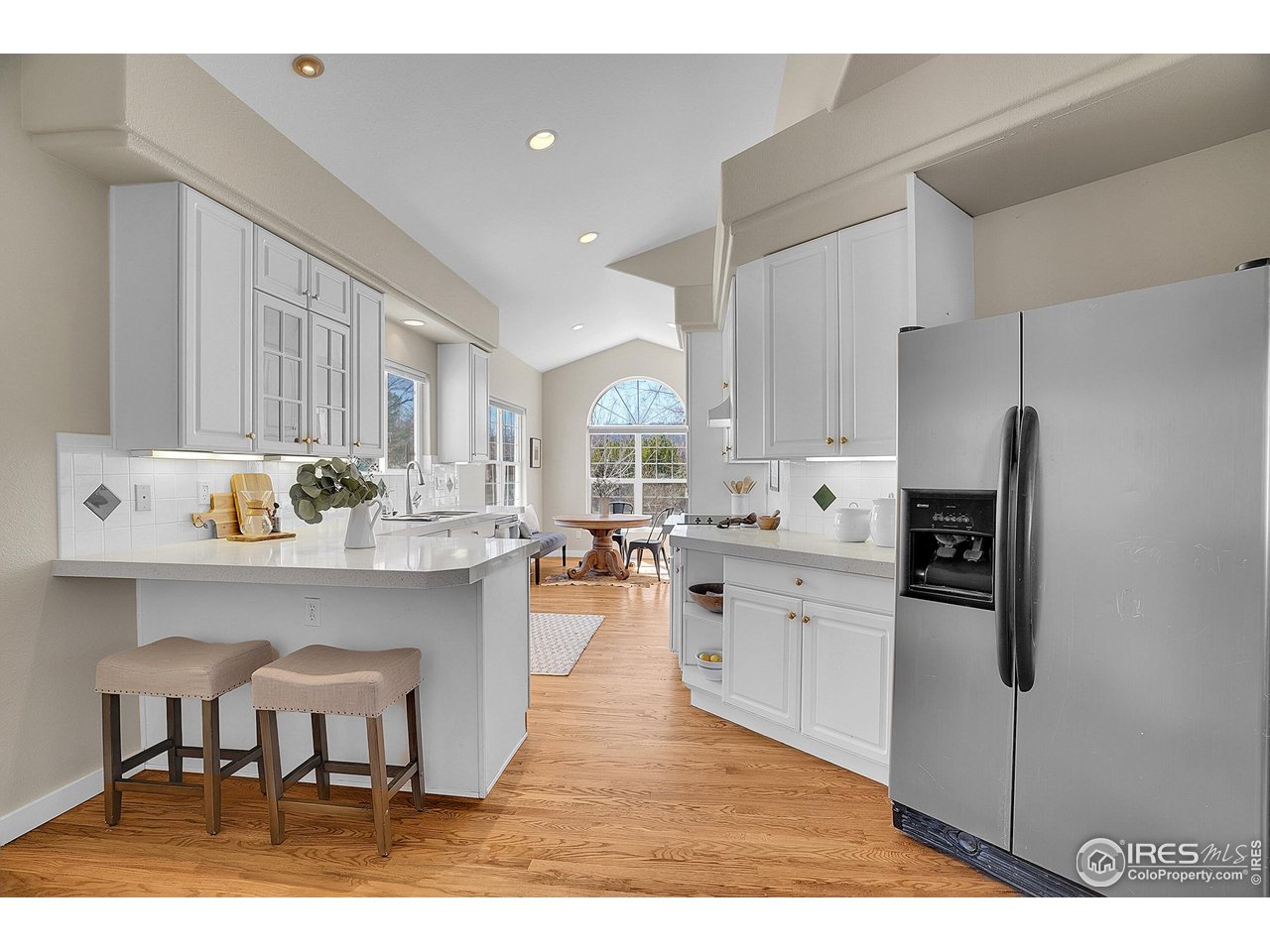 410 High Court Fort Collins, CO 80521 - Photo 8 of 37 a kitchen with white cabinets and refrigerator