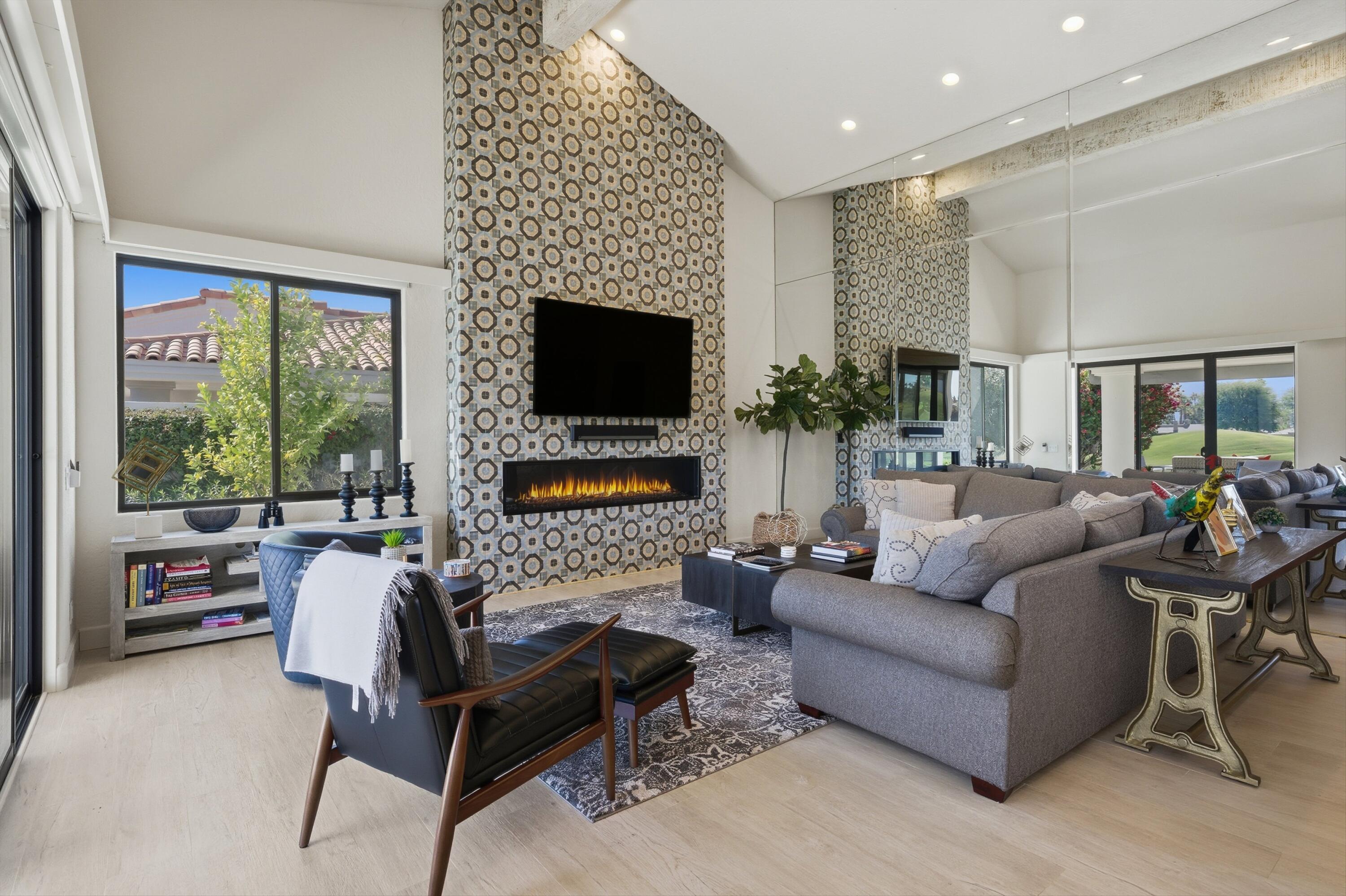 54672 Inverness Way La Quinta, CA 92253 - Photo 12 of 49 a living room with furniture a fireplace and a flat screen tv
